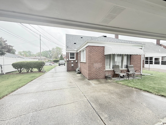 view of side of home featuring brick siding and a shingled roof