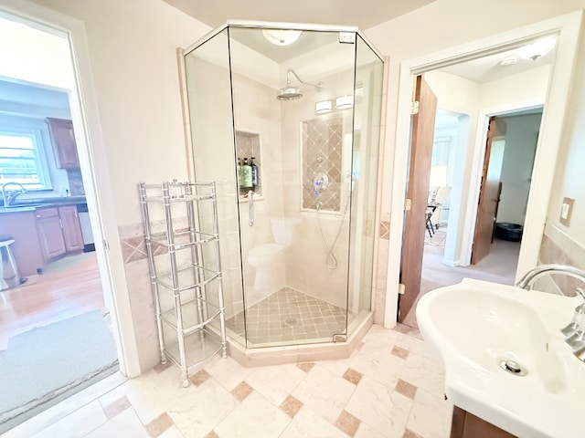 full bath with a sink and a stall shower