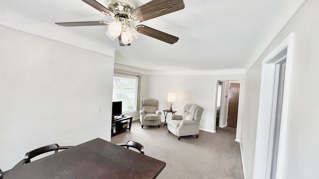 sitting room featuring ceiling fan, light carpet, and baseboards