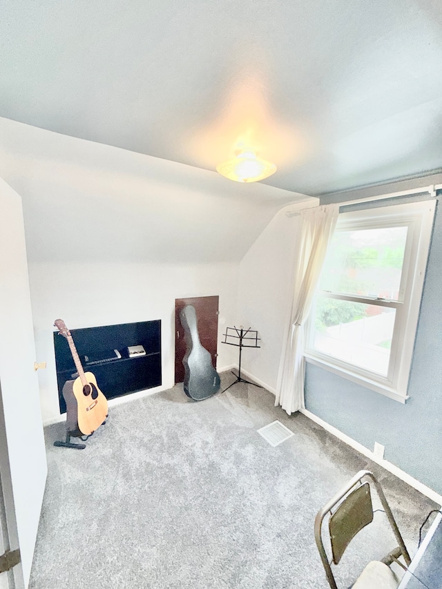 bonus room featuring vaulted ceiling, carpet flooring, and baseboards