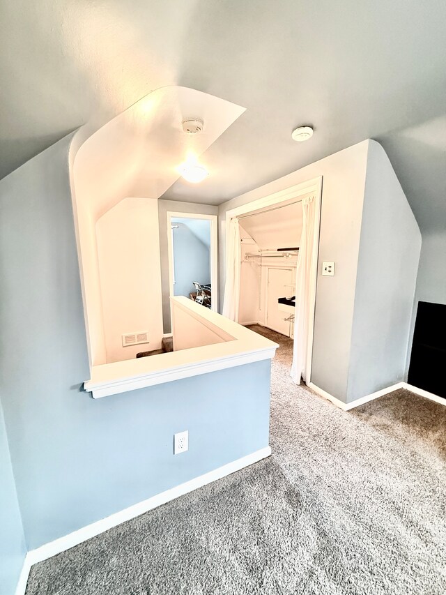 bonus room featuring carpet and baseboards