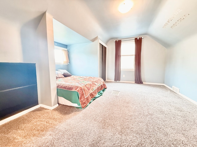 carpeted bedroom with lofted ceiling, multiple windows, and baseboards