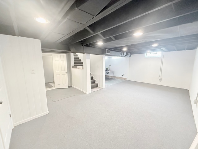 below grade area with stairs and carpet flooring