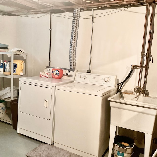 clothes washing area with washer and dryer