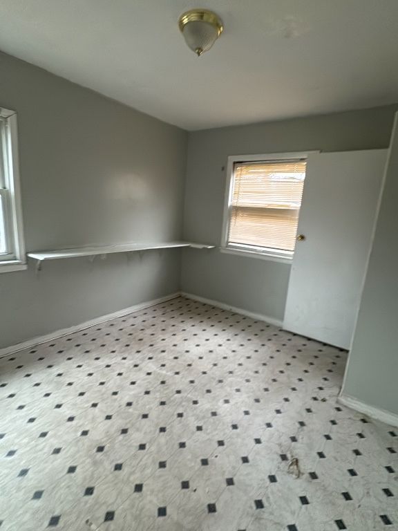 spare room featuring baseboards