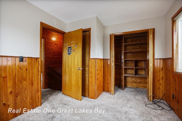 2505 Blake St, Saginaw, MI 48602 - unfurnished bedroom featuring wood walls, wainscoting, and carpet flooring