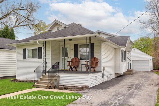 2505 Blake St, Saginaw, MI 48602 - view of front of home featuring covered porch, roof with shingles, an outdoor structure, and driveway