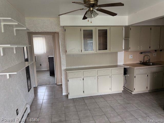 17121 Redford St Unit 212, Detroit, MI 48219 - kitchen featuring a sink, open shelves, ceiling fan, light countertops, and light tile patterned flooring