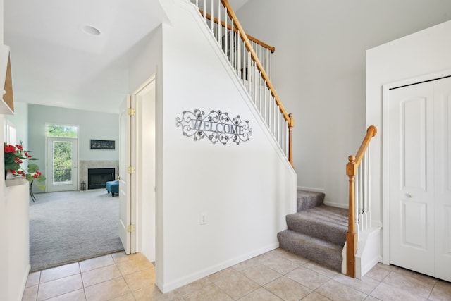 28986 Christopher Ln, Southfield, MI 48034 - stairway with carpet flooring, tile patterned flooring, a fireplace, and baseboards