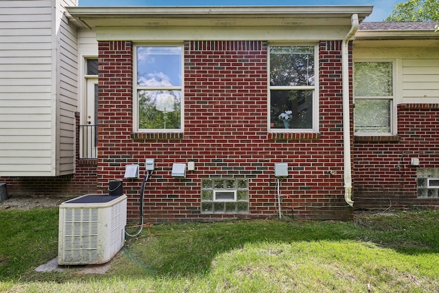 28986 Christopher Ln, Southfield, MI 48034 - view of home's exterior featuring cooling unit, a lawn, and brick siding