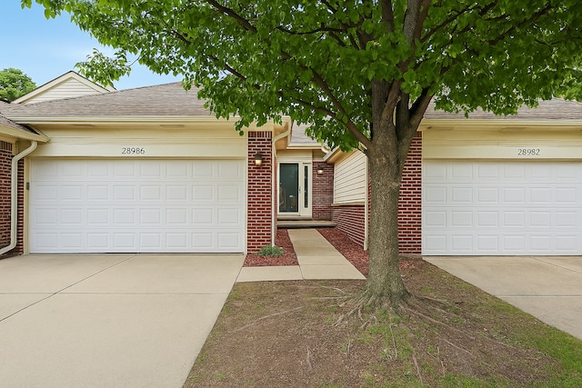 28986 Christopher Ln, Southfield, MI 48034 - view of front of home featuring brick siding, driveway, an attached garage, and a shingled roof