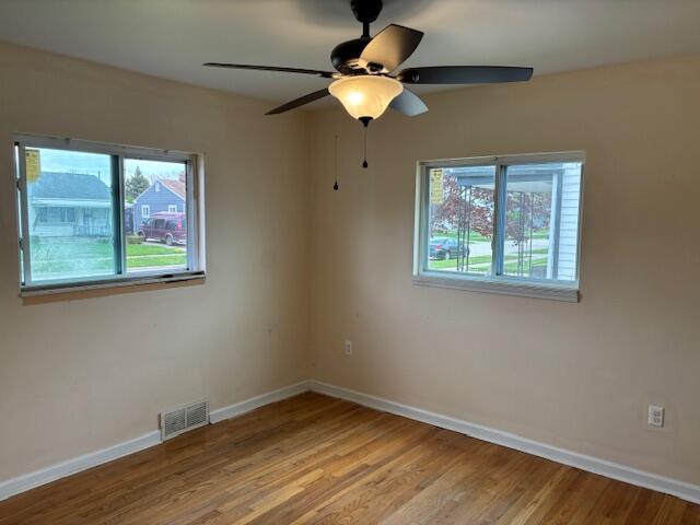 4770 Matthew St, Westland, MI 48186 - spare room with healthy amount of natural light, baseboards, and light wood-style flooring
