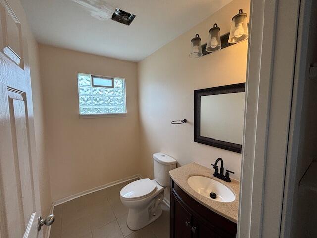 4770 Matthew St, Westland, MI 48186 - bathroom with toilet, vanity, tile patterned flooring, and baseboards