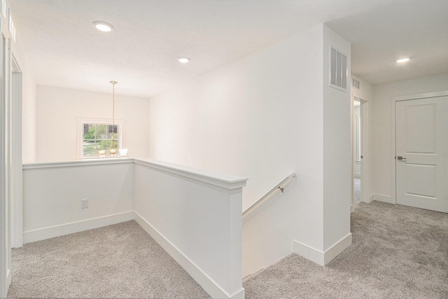 15250 Alister Mackenzie Ave, Augusta, MI 49012 - hall featuring an upstairs landing, carpet flooring, baseboards, recessed lighting, and a chandelier
