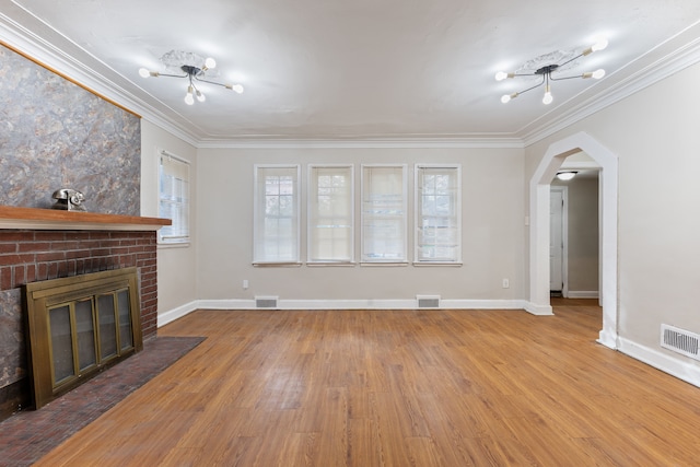 14028 Whitcomb St, Detroit, MI 48227 - unfurnished living room with crown molding, arched walkways, wood finished floors, baseboards, and a brick fireplace