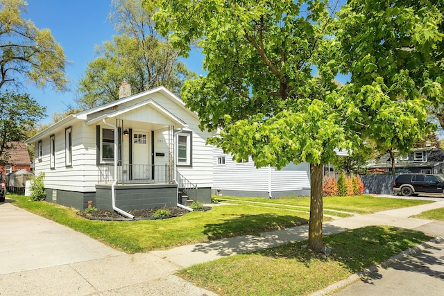 1342 Bertha St, Ferndale, MI 48220 - view of front facade with a front yard, a chimney, and crawl space