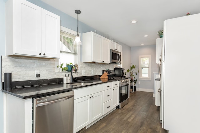 1342 Bertha St, Ferndale, MI 48220 - kitchen with appliances with stainless steel finishes, a sink, tasteful backsplash, white cabinets, and baseboards