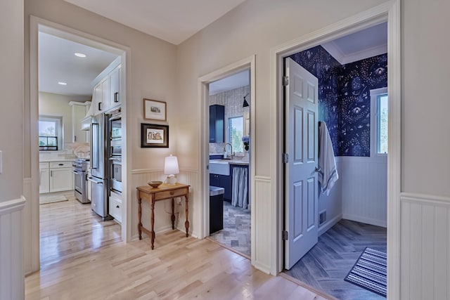 26930 Victory Ct, South Lyon, MI 48178 - hall featuring wainscoting, plenty of natural light, light wood finished floors, and a decorative wall