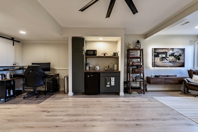 26930 Victory Ct, South Lyon, MI 48178 - office with light wood-style floors, a barn door, and recessed lighting