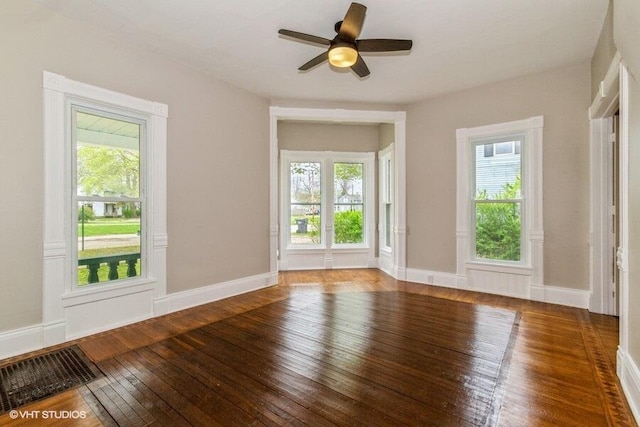 spare room featuring plenty of natural light, hardwood / wood-style flooring, and ceiling fan