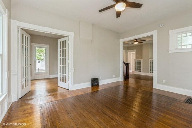 unfurnished room with ceiling fan, hardwood / wood-style flooring, and baseboards