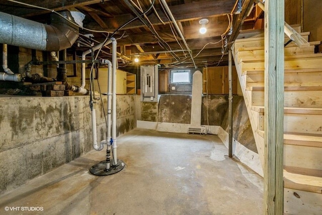 below grade area featuring electric panel and drainage system