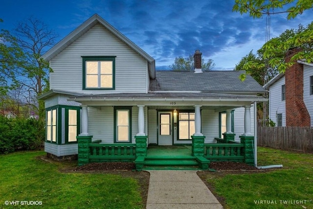 view of front of home with covered porch, a chimney, and roof with shingles