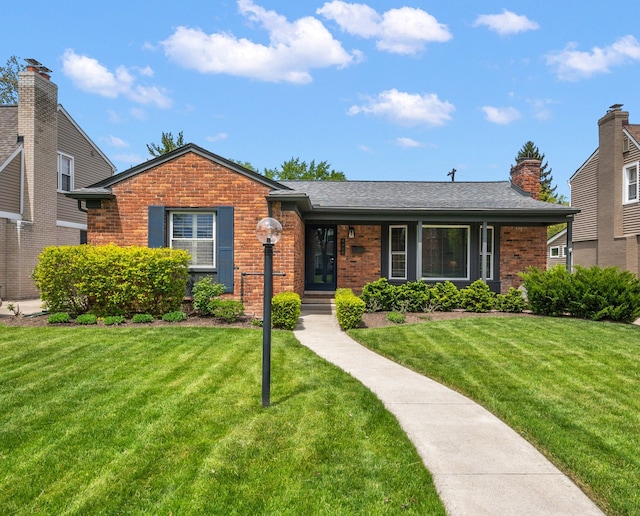 view of front of property with brick siding and a front yard