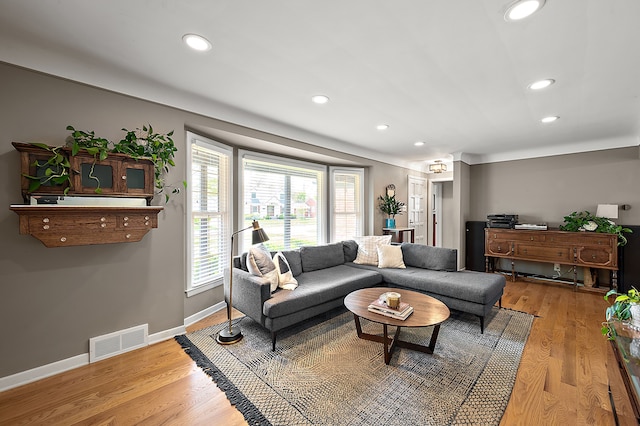 living area with wood finished floors, recessed lighting, and baseboards