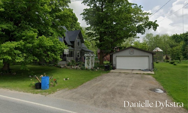 view of property hidden behind natural elements with an outdoor structure, a detached garage, and a front lawn