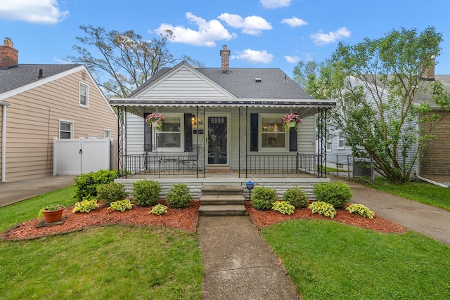 bungalow-style house featuring covered porch, a gate, a chimney, and roof with shingles