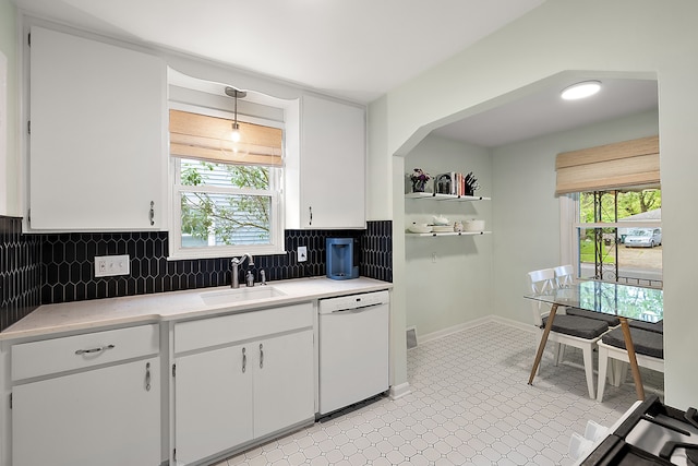 kitchen featuring a sink, white dishwasher, light countertops, and white cabinetry