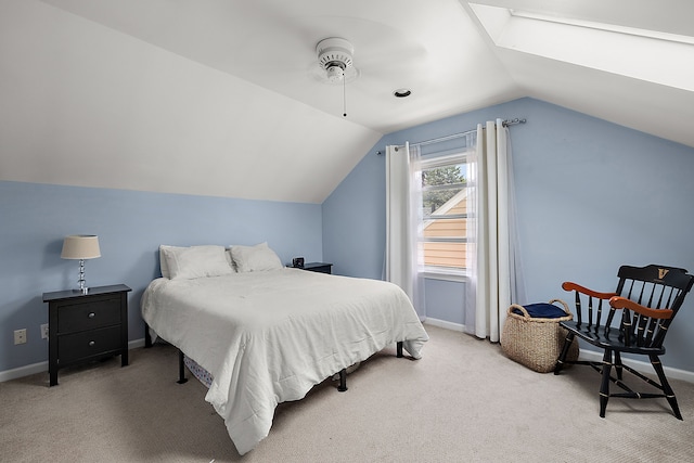 carpeted bedroom featuring lofted ceiling, baseboards, and a skylight