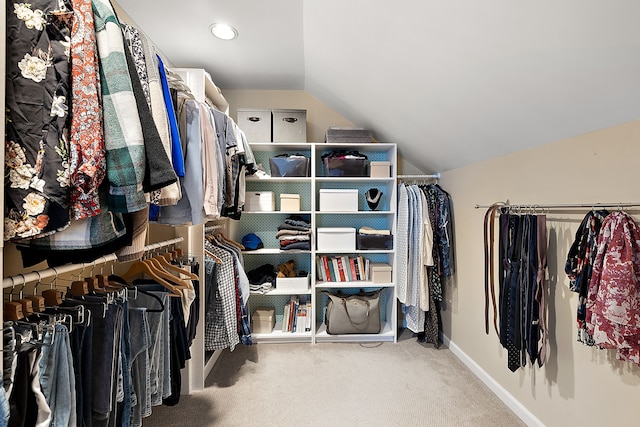 spacious closet with vaulted ceiling and carpet flooring