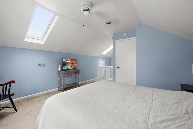 bedroom featuring a skylight, vaulted ceiling, carpet, and baseboards