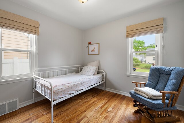 bedroom featuring light wood-type flooring and baseboards