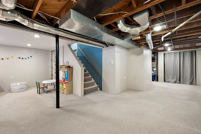 below grade area featuring stairs and carpet flooring