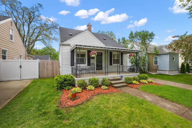 bungalow-style home featuring covered porch, a gate, roof with shingles, and a chimney