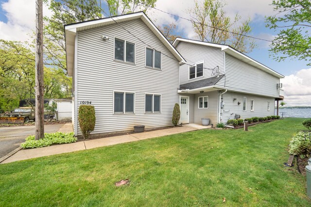 10194 Elmcrest Rd, Whitmore Lake, MI 48189 - rear view of house with a yard