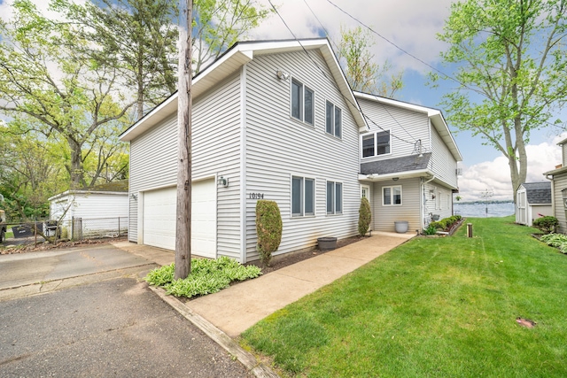 10194 Elmcrest Rd, Whitmore Lake, MI 48189 - back of house featuring asphalt driveway and an attached garage