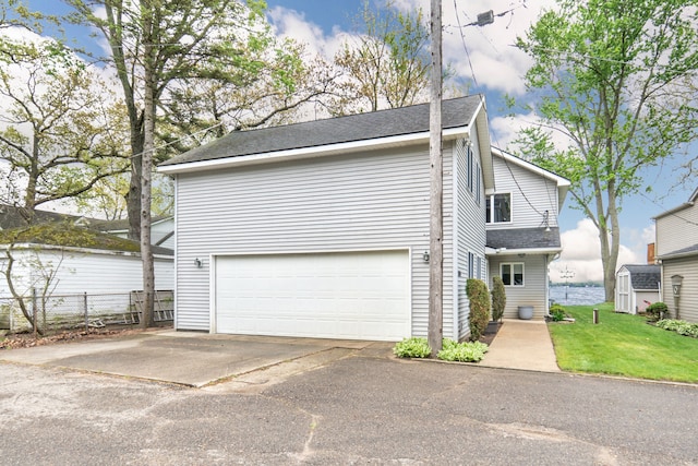 10194 Elmcrest Rd, Whitmore Lake, MI 48189 - view of front of home with a garage and a shingled roof