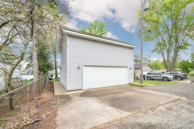 10194 Elmcrest Rd, Whitmore Lake, MI 48189 - garage featuring fence and concrete driveway