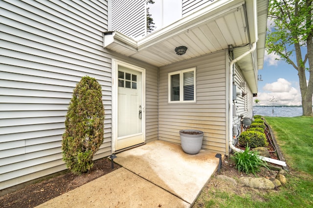 10194 Elmcrest Rd, Whitmore Lake, MI 48189 - property entrance featuring a patio, a water view, and a yard