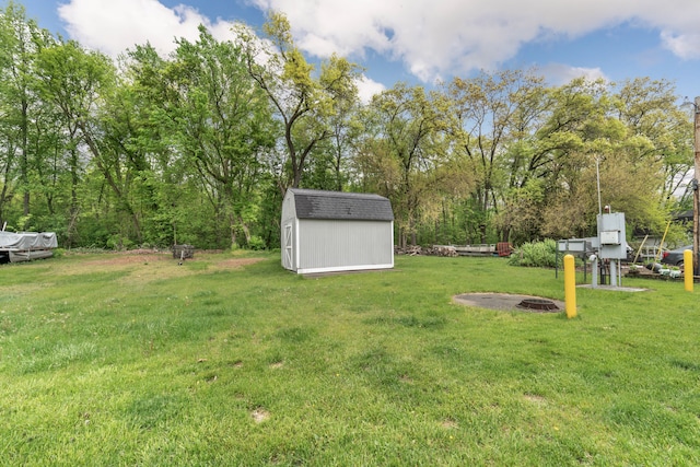 10194 Elmcrest Rd, Whitmore Lake, MI 48189 - view of grassy yard with a storage shed, an outbuilding, and an outdoor fire pit