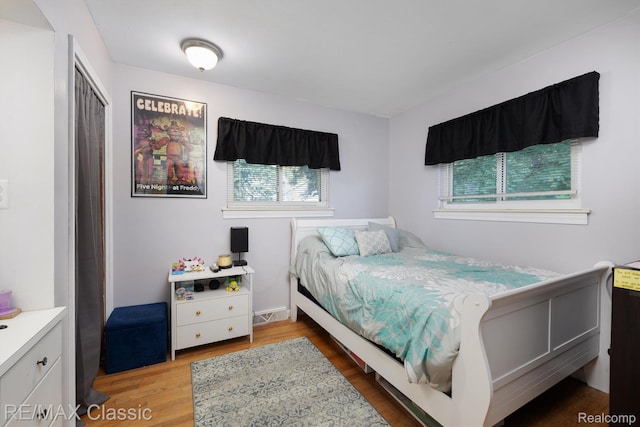 94 Crescent Lake Rd, Waterford, MI 48327 - bedroom with wood finished floors and a closet