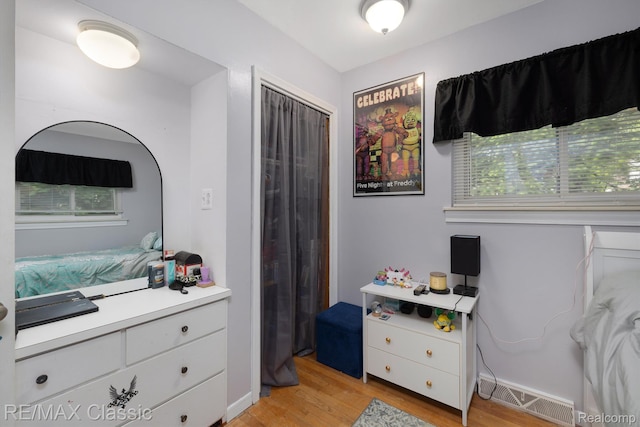 94 Crescent Lake Rd, Waterford, MI 48327 - bedroom with light wood-type flooring and a closet