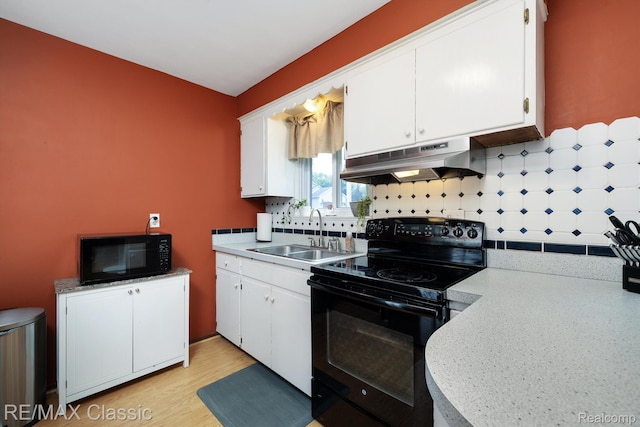 94 Crescent Lake Rd, Waterford, MI 48327 - kitchen featuring black appliances, under cabinet range hood, a sink, and white cabinets