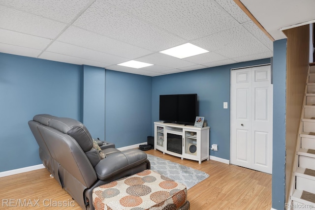 94 Crescent Lake Rd, Waterford, MI 48327 - living room featuring wood finished floors, a paneled ceiling, and baseboards