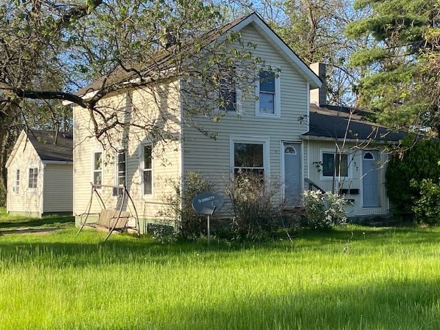 437 W Mount Morris St, Mount Morris, MI 48458 - back of house featuring a chimney