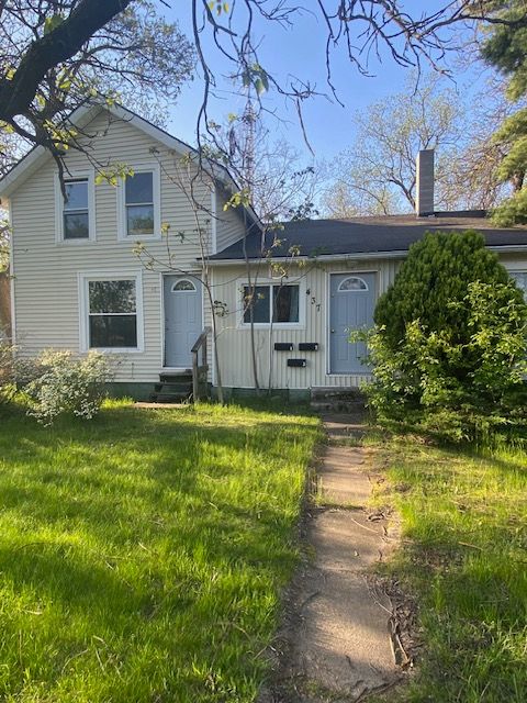 437 W Mount Morris St, Mount Morris, MI 48458 - view of front facade with entry steps, a chimney, and board and batten siding